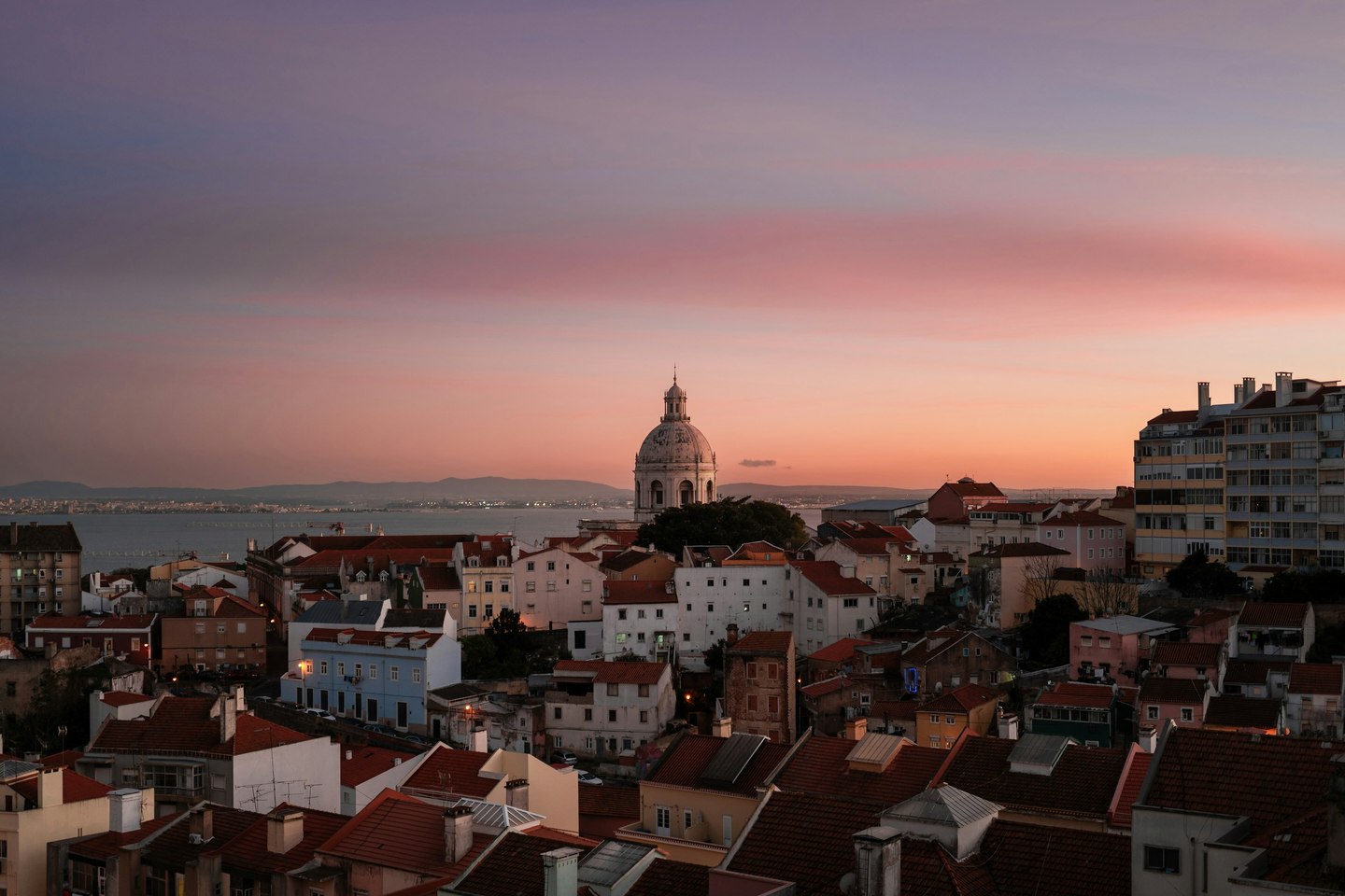 Lisbon rooftops and the river at sunset